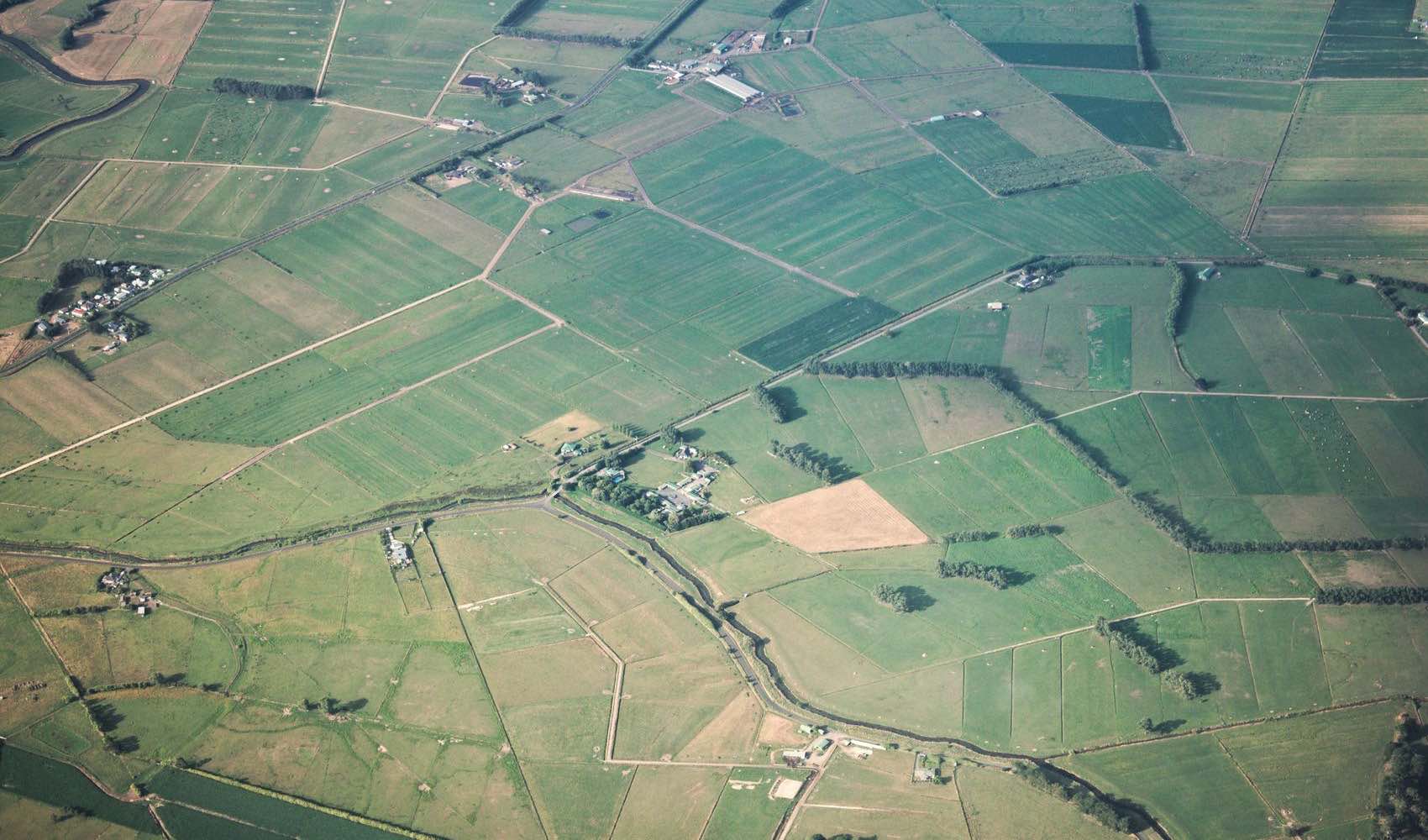 Aerial view of vacant land parcels divided into a patchwork of lots